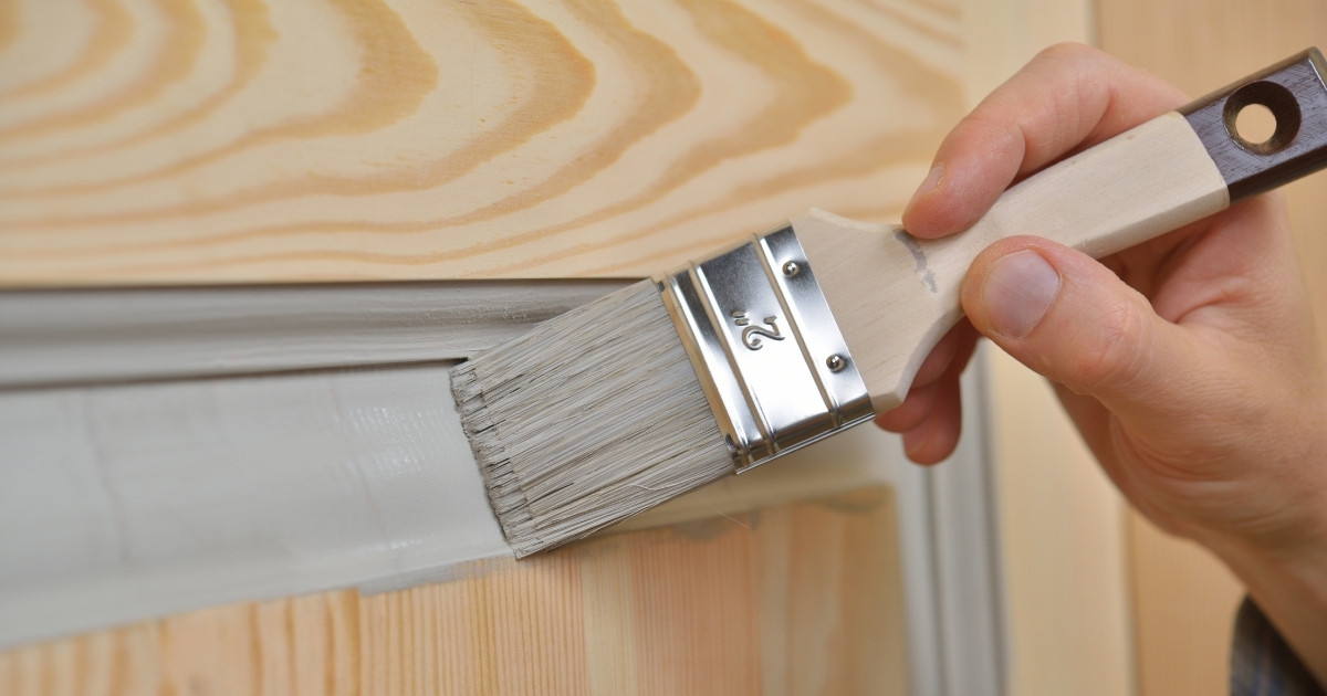 Person painting a door